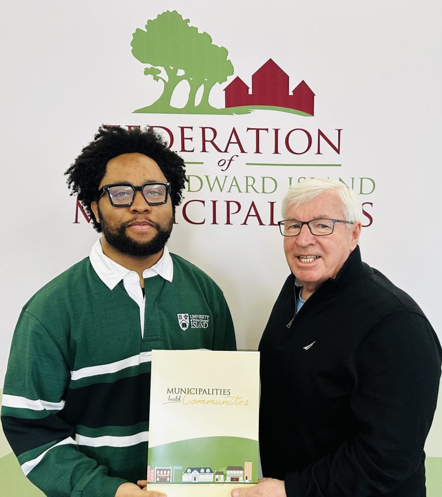 FPEIM President Bruce MacDougall is shown congratulating Joshua Maduka on receiving the FPEIM Gilbert C. Bell Memorial Award.